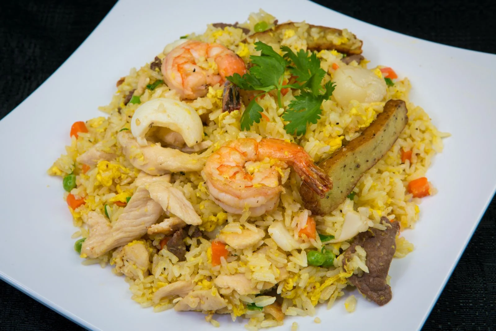 Combination fried rice with shrimp, chicken, beef, egg, and vegetables